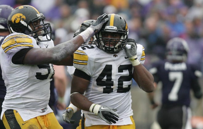 Iowa's Jeremiha Hunter is congratulated by teammate Broderick Binns after an interception, in the fourth quarter Saturday, Nov. 13, 2010, at Ryan Field, in Evanston, Illinois.