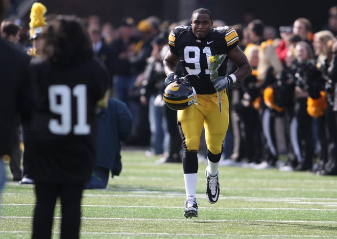 Iowa's Broderick Binns runs out to greet family members during the introduction of the senior players before the start of their game against Michigan State at Kinnick Stadium on Saturday, Sept. 24, 2011.