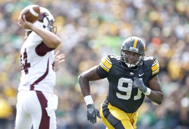 Iowa's Broderick Binns chases after Louisiana-Monroe quarterback Cody Wells during their game at Kinnick Stadium on Saturday, Sept. 24, 2011.