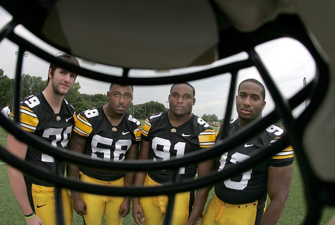 Left to right: Iowa's Dominic Alvis, Lebron Daniel, Broderick Binns and Mike Daniels pose for photographers during the annual Media Day, Friday, Aug. 5, 2011, in Iowa City, Iowa.