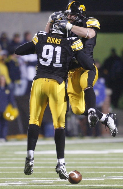 Broderick Binns (91) is congratulated by teammate Pat Angerer (43) in the third quarter Saturday, Oct. 10, 2009, at Kinnick Stadium, in Iowa City, Iowa.