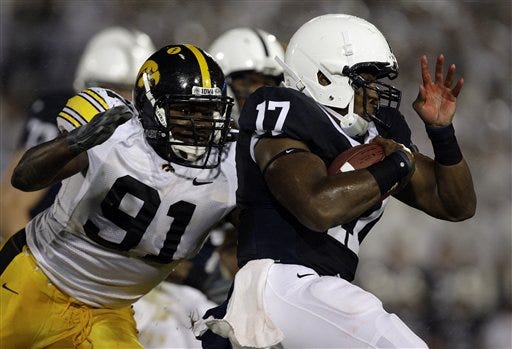Iowa's Broderick Binns (91) closes in on Penn State quarterback Daryll Clark (17)  during the first half of an NCAA college football game Saturday, Sept. 26, 2009, in State College, Pennsylvania.