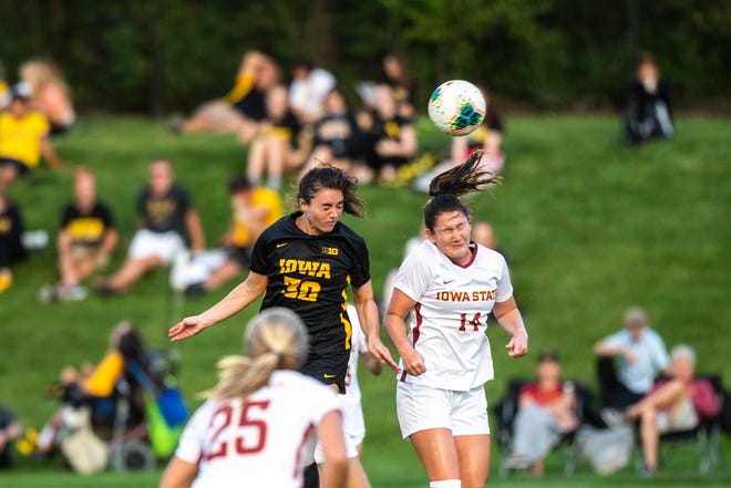 Iowa forward Devin Burns (30) goes up to head a ball against Iowa State defender Taylor Bee (14) during a NCAA women's soccer Cy-Hawk series game, Thursday, Aug. 29, 2019, at the University of Iowa Soccer Complex in Iowa City, Iowa.