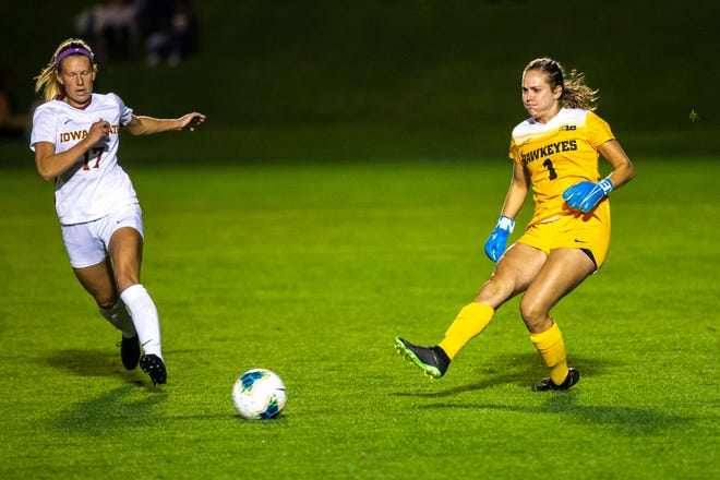 Iowa goalie Claire Graves (1) kicks a ball away from Iowa State forward Merin Mundt (17) during a NCAA women's soccer Cy-Hawk series game, Thursday, Aug. 29, 2019, at the University of Iowa Soccer Complex in Iowa City, Iowa.