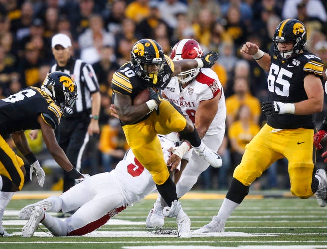 Iowa junior running back Mekhi Sargent runs for extra yards after being in the first quarter against Miami of Ohio at Kinnick Stadium in Iowa City on Saturday, Aug. 31, 2019.