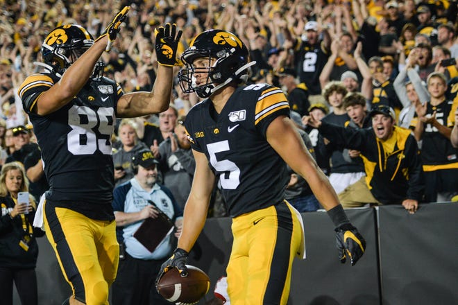 Aug 31, 2019; Iowa City, IA, USA; Iowa Hawkeyes wide receiver Oliver Martin (5) reacts with wide receiver Nico Ragaini (89) after a touchdown pass from quarterback Nate Stanley (not shown) against the Miami (Oh) Redhawks during the third quarter at Kinnick Stadium. Mandatory Credit: Jeffrey Becker-USA TODAY Sports