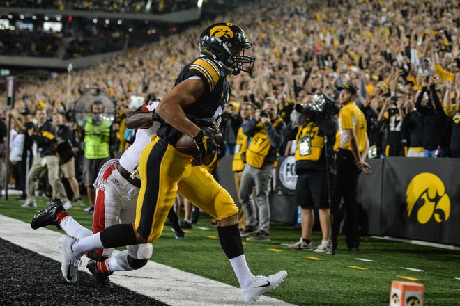 Aug 31, 2019; Iowa City, IA, USA; Iowa Hawkeyes wide receiver Oliver Martin (5) catches a touchdown pass from quarterback Nate Stanley (not shown) as Miami (Oh) Redhawks defensive back Zedrick Raymond (14) defends during the third quarter at Kinnick Stadium. Mandatory Credit: Jeffrey Becker-USA TODAY Sports