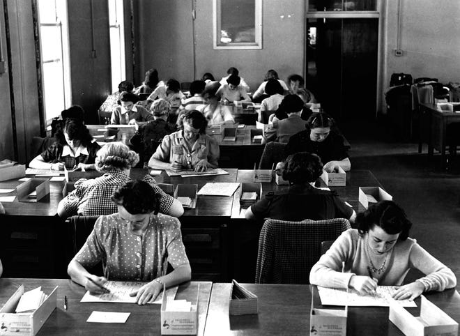 An undated handout photo that shows women hand scoring ACT exams, in Iowa City, Iowa.