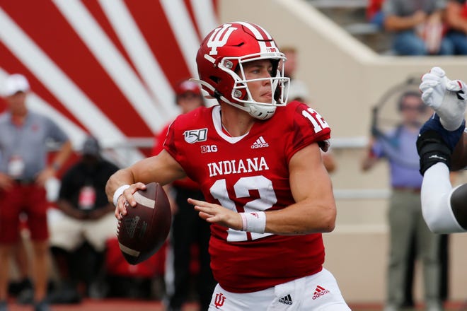 Indiana Hoosiers quarterback Peyton Ramsey (12) throws a pass against the Connecticut Huskies during the second quarter at Memorial Stadium .