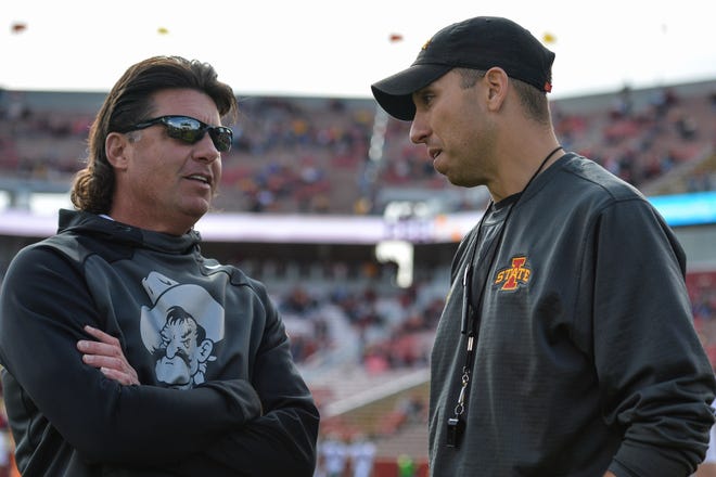 Oct 26, 2019; Ames, IA, USA; Oklahoma State Cowboys head coach Mike Gundy (left) and Iowa State Cyclones head coach Matt Campbell (right) talk before the game at Jack Trice Stadium.