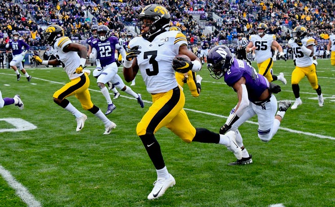 Oct 26, 2019; Evanston, IL, USA; Iowa Hawkeyes wide receiver Tyrone Tracy Jr. (3) runs for a touchdown against Northwestern Wildcats defensive back Greg Newsome II (2) in the first half at Ryan Field. Mandatory Credit: Matt Marton-USA TODAY Sports