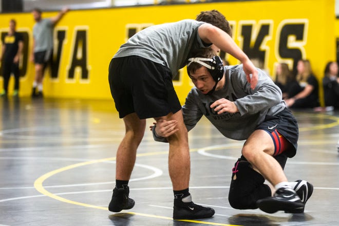 Iowa's Spencer Lee, right, warms up with Gavin Teasdale during the first day of preseason Hawkeye wrestling matches, Thursday, Nov., 7, 2019, inside the Dan Gable Wrestling Complex at Carver-Hawkeye Arena in Iowa City, Iowa.