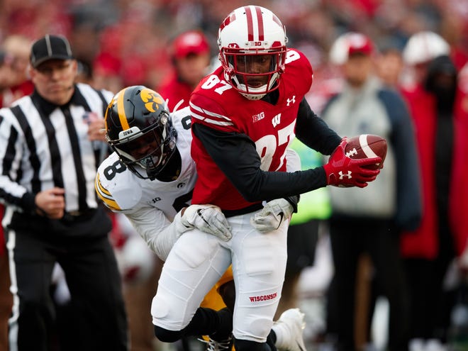 Nov 9, 2019; Madison, WI, USA; Wisconsin Badgers wide receiver Quintez Cephus (87) runs the ball after catching a pass against Iowa Hawkeyes defensive back Matt Hankins (8) during the first quarter at Camp Randall Stadium.