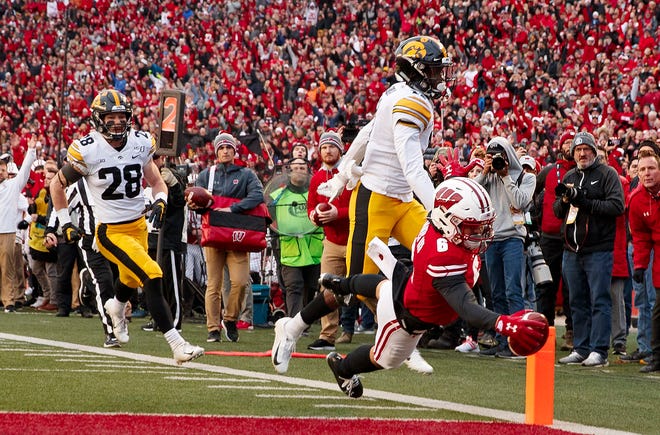 Nov 9, 2019; Madison, WI, USA; Wisconsin Badgers wide receiver Danny Davis III (6) dives to score a touchdown against the Iowa Hawkeyes during the second quarter at Camp Randall Stadium.