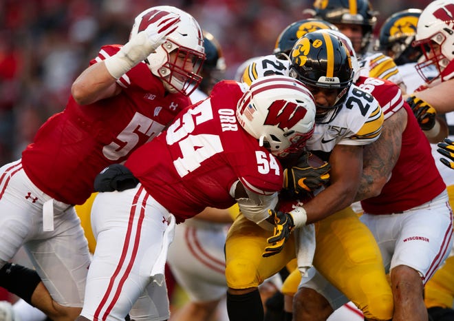Nov 9, 2019; Madison, WI, USA; Iowa Hawkeyes running back Toren Young (28) is tackled by Wisconsin Badgers linebacker Chris Orr (54) during the second quarter at Camp Randall Stadium.