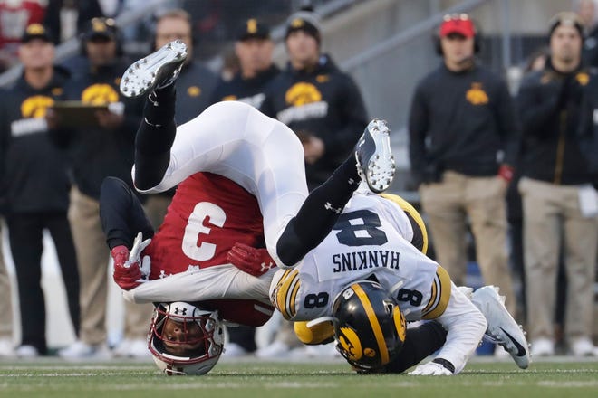 Iowa's Matt Hankins breaks up a pass intended for Wisconsin's Kendric Pryor during the first half of an NCAA college football game Saturday, Nov. 9, 2019, in Madison, Wis. (AP Photo/Morry Gash)