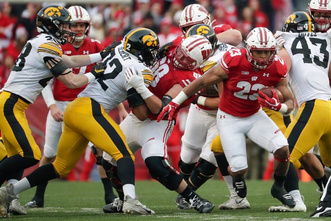 Wisconsin's Jonathan Taylor runs during the first half of an NCAA college football game against Iowa Saturday, Nov. 9, 2019, in Madison, Wis. (AP Photo/Morry Gash)