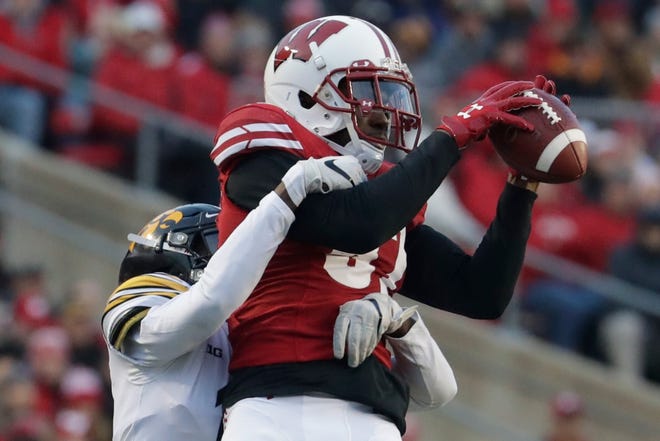 Wisconsin's Quintez Cephus catches a pass in front of Iowa's Michael Ojemudia during the first half of an NCAA college football game Saturday, Nov. 9, 2019, in Madison, Wis. (AP Photo/Morry Gash)