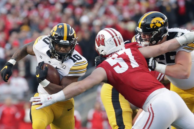 Iowa's Mekhi Sargent runs past Wisconsin's Jack Sanborn during the first half of an NCAA college football game Saturday, Nov. 9, 2019, in Madison, Wis. (AP Photo/Morry Gash)