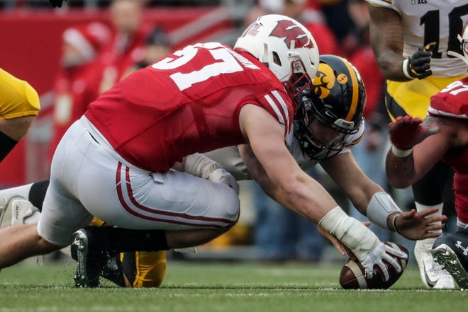 Wisconsin's Jack Sanborn recovers a fumble in front of Iowa's Nate Stanley during the first half of an NCAA college football game Saturday, Nov. 9, 2019, in Madison, Wis. (AP Photo/Morry Gash)