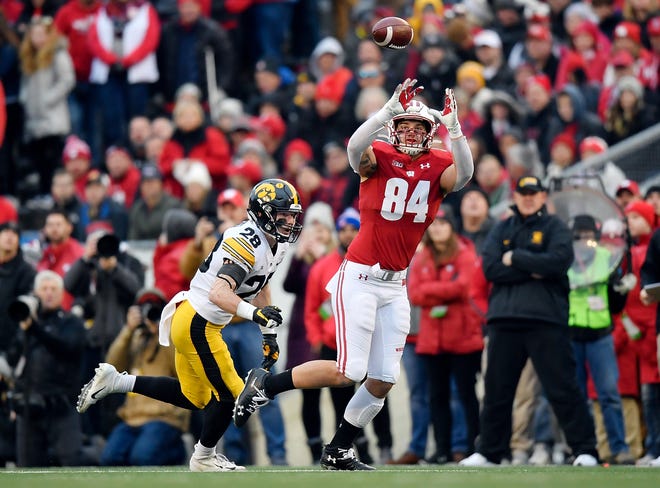 MADISON, WISCONSIN - NOVEMBER 09: Jake Ferguson #84 of the Wisconsin Badgers catches a pass in the first half against Jack Koerner #28 of the Iowa Hawkeyes at Camp Randall Stadium on November 09, 2019 in Madison, Wisconsin. (Photo by Quinn Harris/Getty Images)