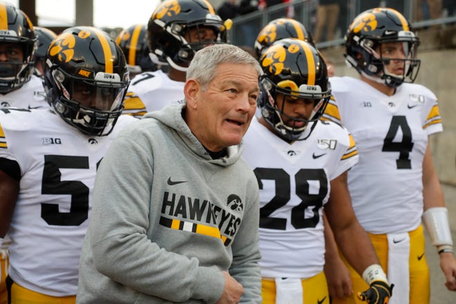 Iowa head coach Kirk Ferentz leads his team on the field before an NCAA college football game against Wisconsin Saturday, Nov. 9, 2019, in Madison, Wis. (AP Photo/Morry Gash)