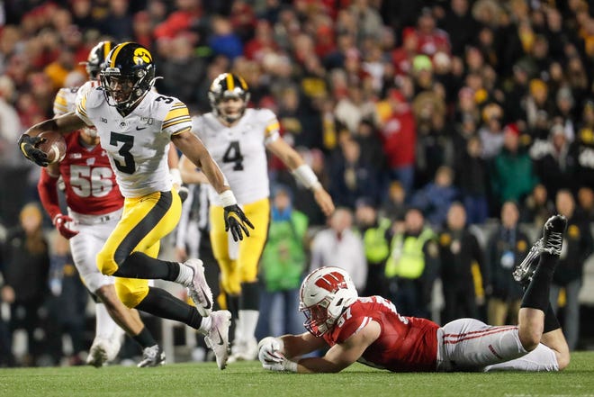 Iowa's Tyrone Tracy Jr. gets past Wisconsin's Jack Sanborn during the second half of an NCAA college football game Saturday, Nov. 9, 2019, in Madison, Wis. Wisconsin won 24-22. (AP Photo/Morry Gash)