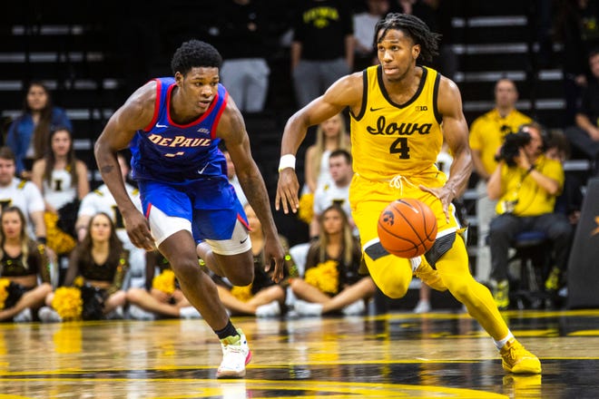 Iowa guard Bakari Evelyn (4) gets a steal as DePaul's Romeo Weems (1) defends during a NCAA non-conference men's basketball game, Monday, Nov., 11, 2019, at Carver-Hawkeye Arena in Iowa City, Iowa.