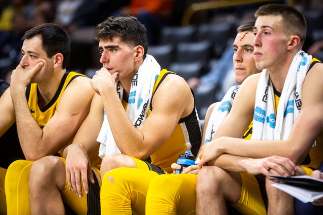 Iowa players, from left, Ryan Kriener, Luka Garza, Connor McCaffery, and Joe Wieskamp sit on the bench in the second half during a NCAA non-conference men's basketball game, Monday, Nov., 11, 2019, at Carver-Hawkeye Arena in Iowa City, Iowa.