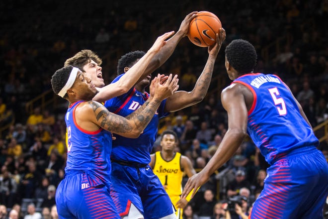 Iowa forward Patrick McCaffery (22) attempts to grab a rebound against DePaul defenders Devin Gage, Romeo Weems, and Jalen Coleman-Lands (5) during a NCAA non-conference men's basketball game, Monday, Nov., 11, 2019, at Carver-Hawkeye Arena in Iowa City, Iowa.