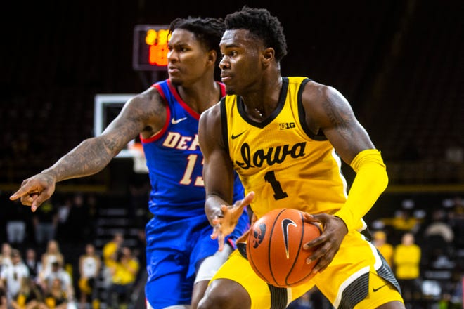 Iowa guard Joe Toussaint (1) drives to the basket against DePaul's Darious Hall (13) during a NCAA non-conference men's basketball game, Monday, Nov., 11, 2019, at Carver-Hawkeye Arena in Iowa City, Iowa.