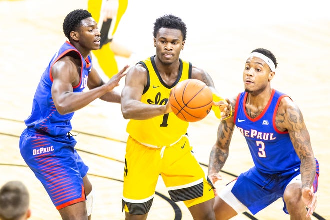 Iowa guard Joe Toussaint (1) passes while DePaul's 	Romeo Weems, left, and Devin Gage (3) defend during a NCAA non-conference men's basketball game, Monday, Nov., 11, 2019, at Carver-Hawkeye Arena in Iowa City, Iowa.