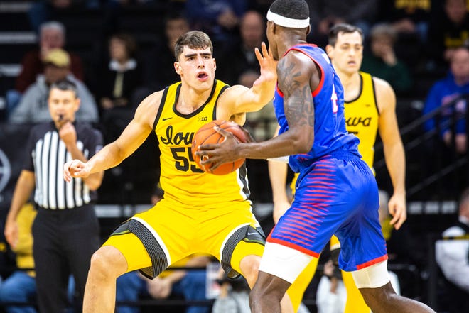 Iowa center Luka Garza (55) defends DePaul's Paul Reed (4) during a NCAA non-conference men's basketball game, Monday, Nov., 11, 2019, at Carver-Hawkeye Arena in Iowa City, Iowa.