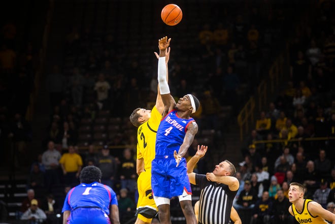 Iowa forward Jack Nunge (2) loses the opening tip to DePaul's Paul Reed (4) during a NCAA non-conference men's basketball game, Monday, Nov., 11, 2019, at Carver-Hawkeye Arena in Iowa City, Iowa.