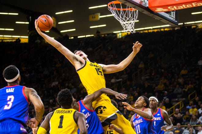 Iowa forward Ryan Kriener (15) pulls down a rebound as DePau's Charlie Moore (11) defends during a NCAA non-conference men's basketball game, Monday, Nov., 11, 2019, at Carver-Hawkeye Arena in Iowa City, Iowa.