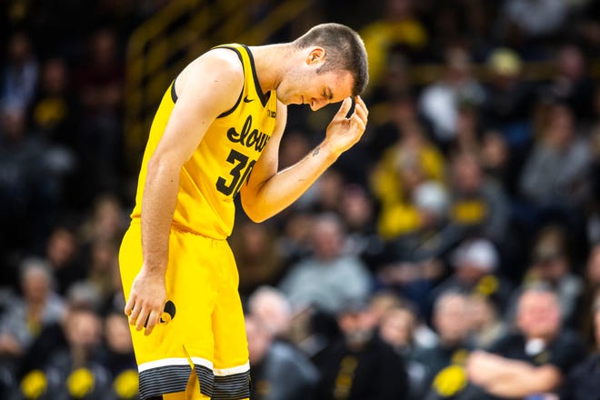 Iowa guard Connor McCaffery (30 winces while reaching for his head during a NCAA non-conference men's basketball game, Monday, Nov., 11, 2019, at Carver-Hawkeye Arena in Iowa City, Iowa.