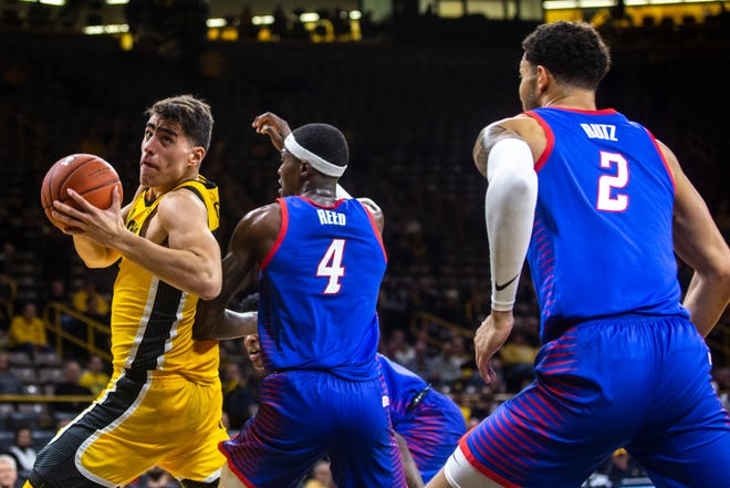 Iowa center Luka Garza, left, drives to the basket against Paul Reed (4) during a NCAA non-conference men's basketball game, Monday, Nov., 11, 2019, at Carver-Hawkeye Arena in Iowa City, Iowa.