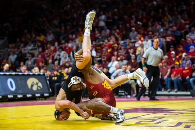 Iowa’s Kaleb Young wrestles Iowa State’s David Carr at 157 during the Cy-Hawk dual on Sunday, Nov. 17, 2019, in Hilton Coliseum.