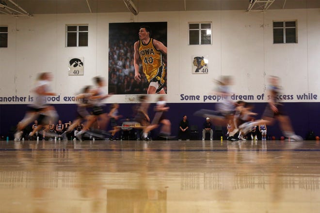 Players run past the mural of Indianola High School and University of Iowa star Chris Street during a game in the Chris Street Memorial Gym at the Indianola Middle School. The Indianola Athletic Booster Club hosted the Chris Street Memorial Basketball Tournament for boys and girls in grades four through eight on Nov. 16 attracting teams from across the Midwest. Additional competitions will be held on Dec. 7 and Jan. 11.