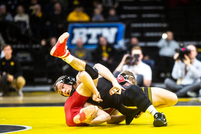 Iowa's Spencer Lee, left, wrestles Wisconsin's Michael Cullen during a NCAA Big Ten Conference wrestling dual, Sunday, Dec. 1, 2019, at Carver-Hawkeye Arena in Iowa City, Iowa.