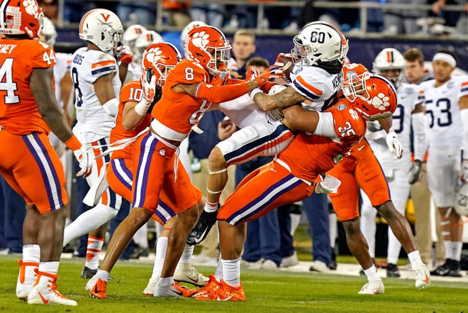 Clemson Tigers defensive end Justin Foster (35) pulls down Virginia Cavaliers running back Billy Kemp IV in the second quarter of the ACC championship game.