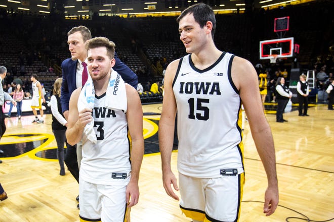 Iowa guard Jordan Bohannon (3) and Iowa forward Ryan Kriener (15) walk off the court together after a NCAA Big Ten Conference men's basketball game against Minnesota, Monday, Dec. 9, 2019, at Carver-Hawkeye Arena in Iowa City, Iowa.
