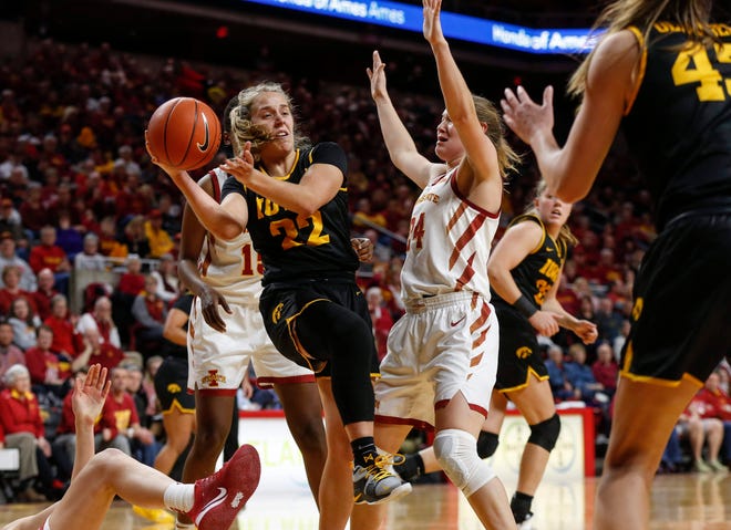 Iowa senior Kathleen Doyle secures a rebound against Iowa State during the CyHawk Series women's basketball game on Wednesday, Dec. 11, 2019, at Hilton Coliseum in Ames, Iowa.
