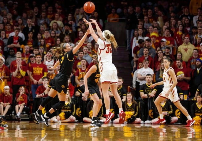 Iowa State freshman Maggie Espenmiller-McGraw launches a three-point shot over the reach of Iowa senior Makenzie Meyer in the first quarter during the CyHawk Series women's basketball game on Wednesday, Dec. 11, 2019, at Hilton Coliseum in Ames, Iowa.