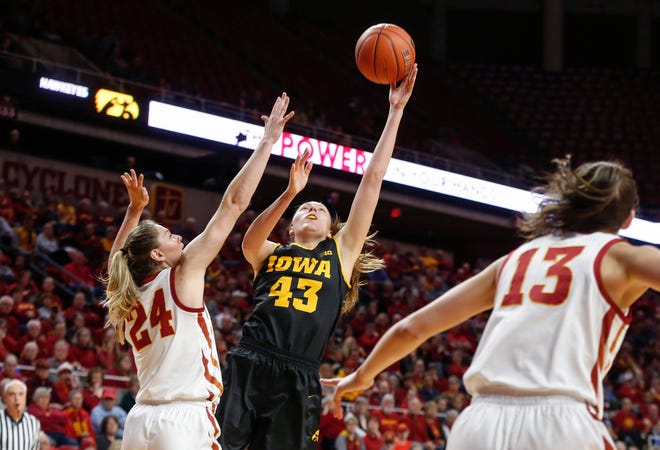 Iowa senior Amanda Ollinger puts a shot up over the defense of Iowa State sophomore Ashley Joens in the first quarter during the CyHawk Series women's basketball game on Wednesday, Dec. 11, 2019, at Hilton Coliseum in Ames, Iowa.