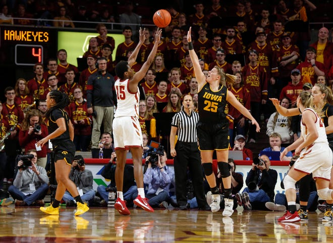 Iowa State senior Ines Nezerwa fires a three-point field goal over the reach of Iowa's Monika Czinano in the first quarter during the CyHawk Series women's basketball game on Wednesday, Dec. 11, 2019, at Hilton Coliseum in Ames, Iowa.