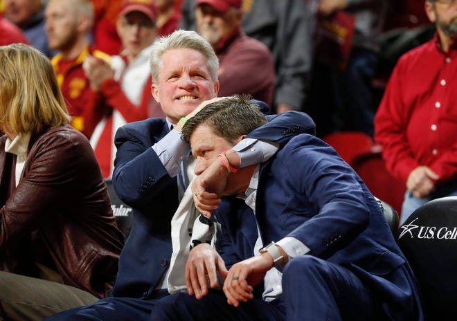 Iowa State women's basketball head coach Bill Fennelly hugs his son, assistant coach Billy Fennelly, after a moment of silence observing the passing of Bill Fennelly's father, who passed away Wednesday morning. The moment of silence came before tipoff against Iowa during the CyHawk Series women's basketball game on Wednesday, Dec. 11, 2019, at Hilton Coliseum in Ames, Iowa.