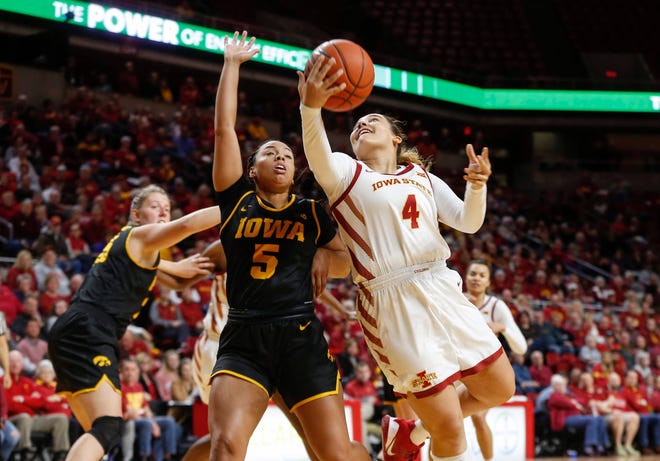 Iowa State junior Rae Johnson drives in as Iowa's Alexis Sevillian defends under the basket in the fourth quarter during the CyHawk Series women's basketball game on Wednesday, Dec. 11, 2019, at Hilton Coliseum in Ames, Iowa.