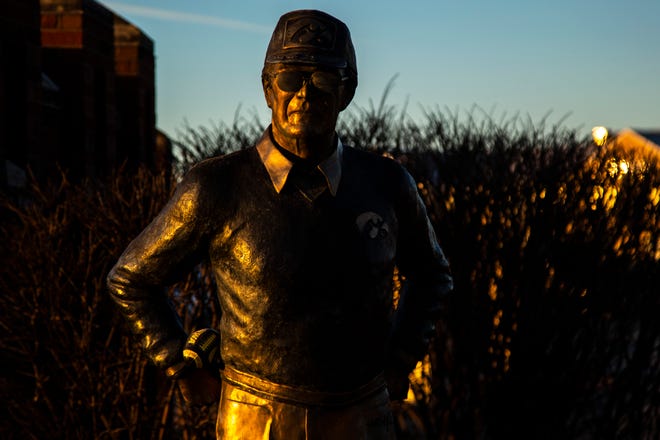 A statue of former Iowa Hawkeyes football head coach Hayden Fry is pictured as the sun rises, Wednesday, Dec. 18, 2019, along First Avenue/Hayden Fry Way near the Iowa City/Coralville Area Convention & Visitors Bureau in Coralville, Iowa. Fry died Dec. 17, he was 90 years old.