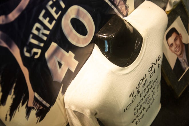 A t-shirt and images of Chris Street are displayed, Wednesday, Dec. 18, 2019, at University of Iowa Athletics Hall of Fame in Iowa City, Iowa.